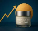 En burk ansiktskräm "Anti Age" står framför en gul cirkel. En gul pil som pekar uppåt symboliserar framgång. Krämen är icke komedogen.