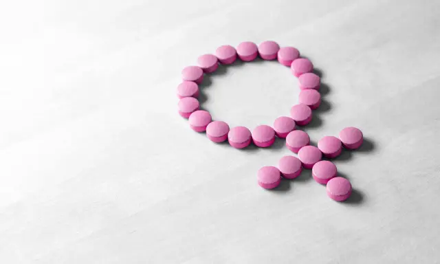 Rosa piller formar kvinnosymbolen. Kan symbolisera hormonbehandling, eller att urin luktar illa klimakteriet.